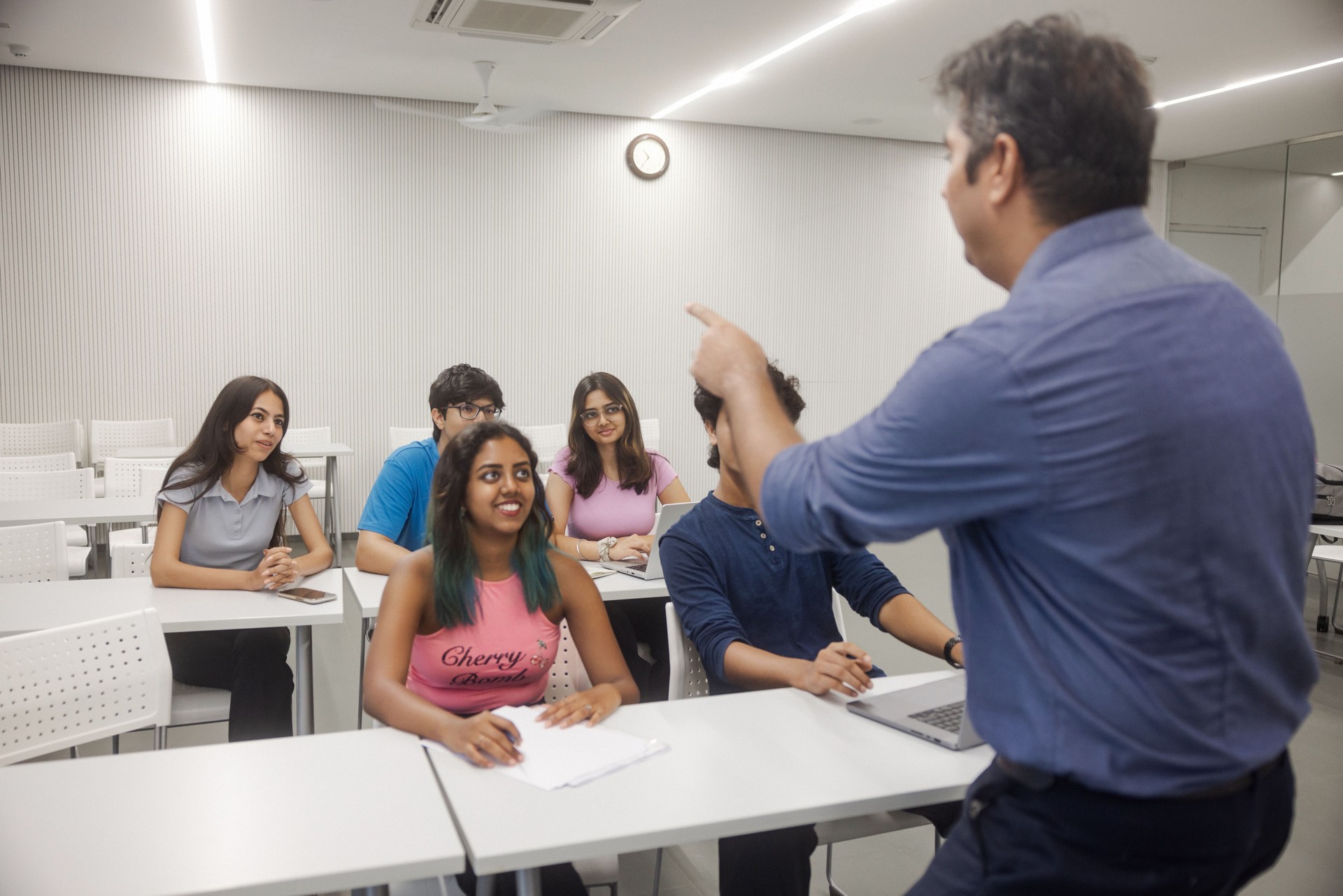 Indian college students on campus interacting with faculty